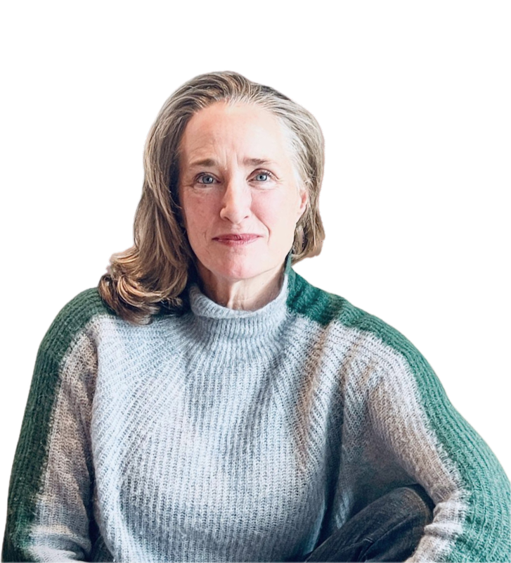 Heilpraktikerin Adrienne Wright Bulow – Porträtaufnahme im gestrickten Pullover, freundlich und zugewandt, sitzt mit entspanntem Blick im Bildausschnitt.