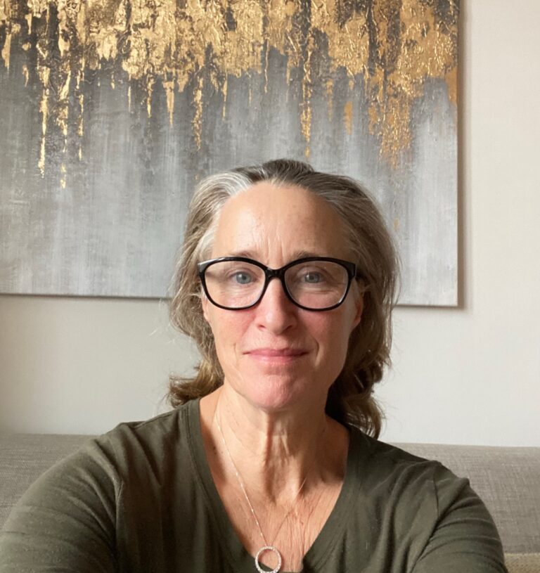 Portrait von Adrienne mit Brille vor goldener Leinwand
